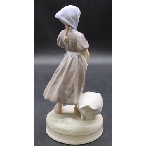 102 - A Royal Copenhagen figure of a young girl with a goose, number 527, 23cm high