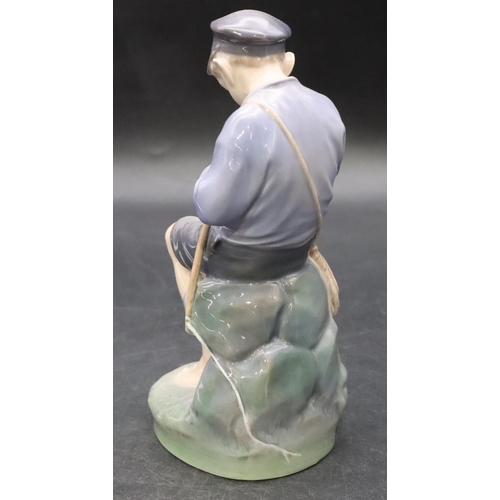 103 - A Royal Copenhagen figure of a young seated boy whittling a stick, number 905, 18.5cm high