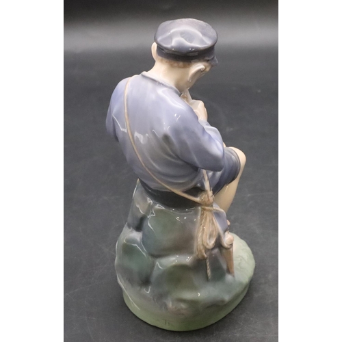 103 - A Royal Copenhagen figure of a young seated boy whittling a stick, number 905, 18.5cm high