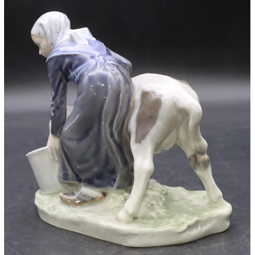 104 - A Royal Copenhagen group of a young girl and calf, number 779, 16cm high