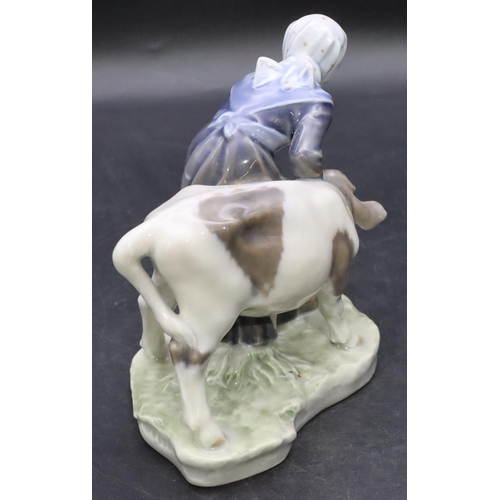 104 - A Royal Copenhagen group of a young girl and calf, number 779, 16cm high