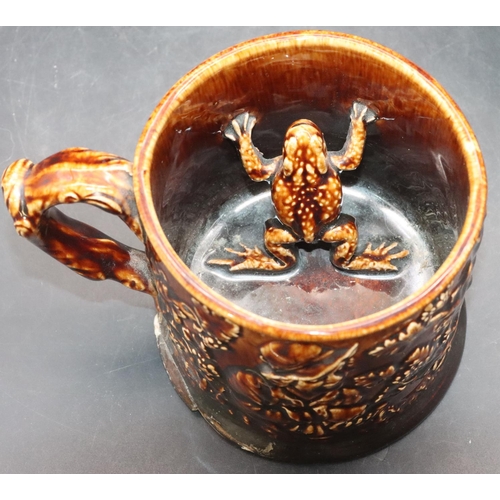 106 - A china frog mug on brown ground with raised figure, grape and vine decoration (chip to rim), 10.5cm... 