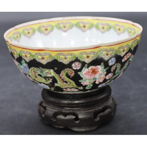 11 - An Oriental egg shell bowl on black and white ground with multi-coloured dragon, floral and scroll d... 