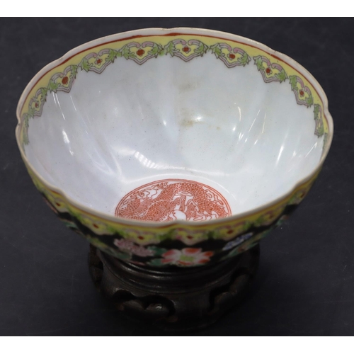 11 - An Oriental egg shell bowl on black and white ground with multi-coloured dragon, floral and scroll d... 