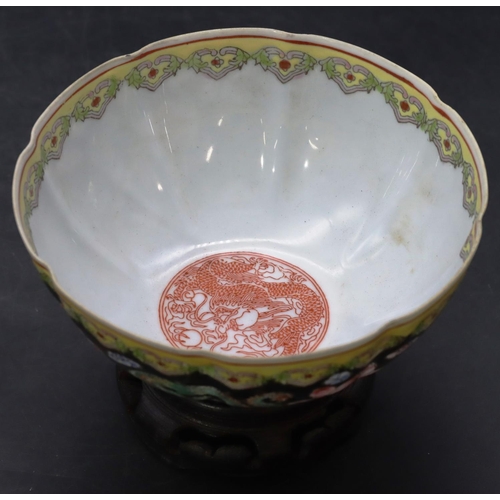 11 - An Oriental egg shell bowl on black and white ground with multi-coloured dragon, floral and scroll d... 