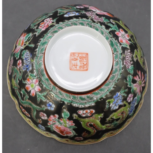 11 - An Oriental egg shell bowl on black and white ground with multi-coloured dragon, floral and scroll d... 