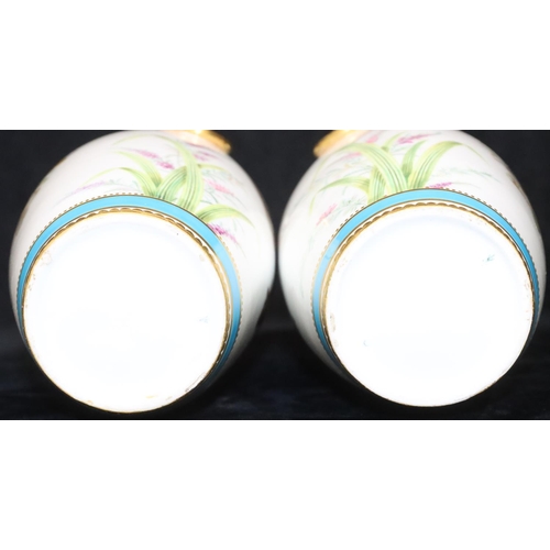 112 - A pair of Minton round bulbous thin necked trumpet shaped vases on white and turquoise ground with m... 