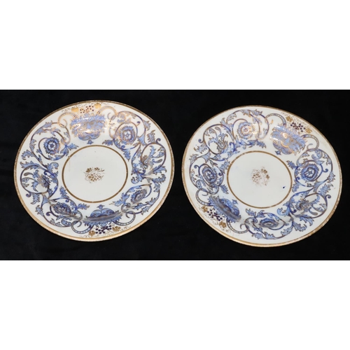 113 - A pair of 19th Century round plates on white and blue ground with mask head, floral, leaf, scroll an... 