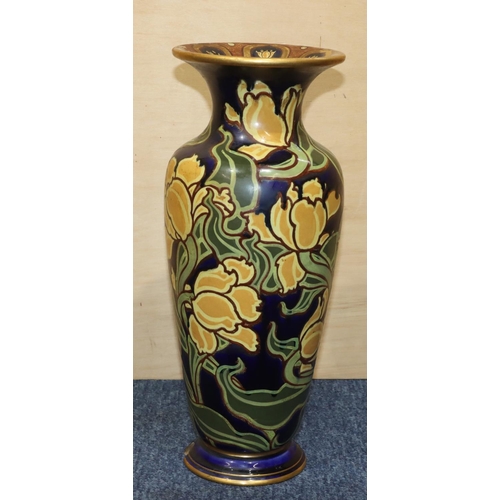 12 - A Doulton & Burslem round bulbous thin necked trumped shaped vase on blue ground with yellow and gre... 