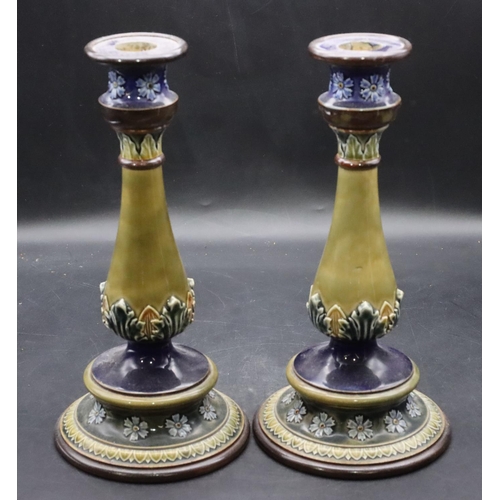 120 - A pair of Royal Doulton glazed earthenware round bulbous candlesticks on blue and green ground with ... 