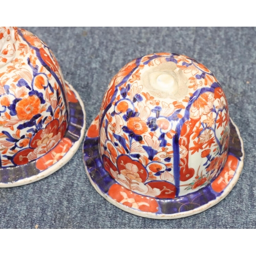 124 - A pair of Imari round bulbous lidded ginger jars on white, red and blue ground with allover floral, ... 