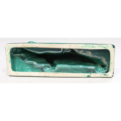 131 - A large green glazed model of a prowling lion on rectangular shaped base, 45cm long, 25cm high