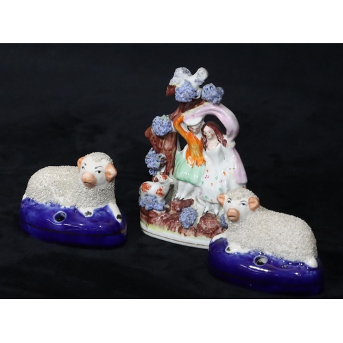 134 - A 19th Century small Staffordshire group of 2 seated figures with sheep at their feet, 12cm high and... 