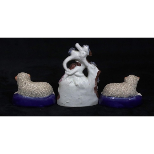 134 - A 19th Century small Staffordshire group of 2 seated figures with sheep at their feet, 12cm high and... 