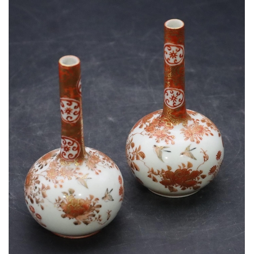 138 - A pair of Oriental small round bulbous thin necked vases on white and red ground with coloured bird,... 