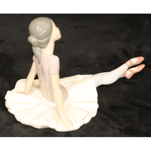 145 - A Lladro figure of a seated ballerina, 15cm high, 25cm long