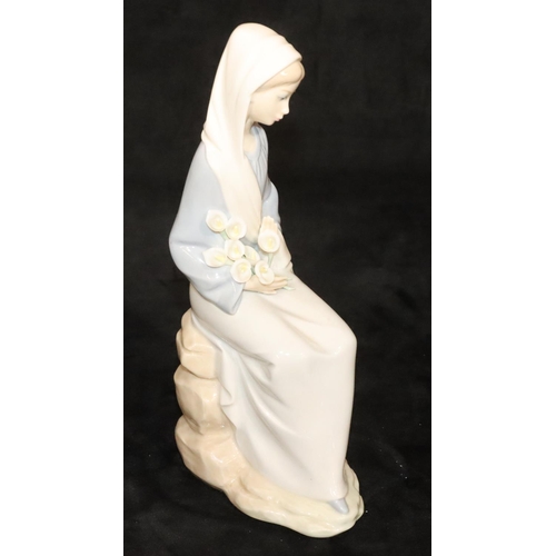 146 - A Lladro figure of a seated lady holding flowers, 24cm high