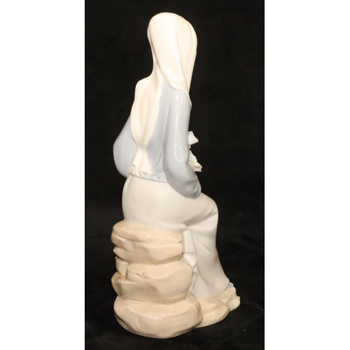 146 - A Lladro figure of a seated lady holding flowers, 24cm high