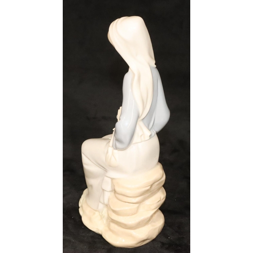 146 - A Lladro figure of a seated lady holding flowers, 24cm high