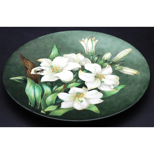 151 - A Victorian glazed china round plaque with hand painted bee in amongst Lilies, 31.5cm diameter