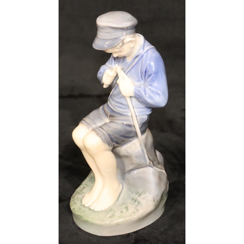 154 - A Royal Copenhagen figure of a young seated boy whittling a stick, number 905, 18.5cm high