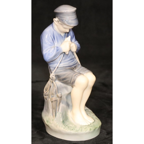 154 - A Royal Copenhagen figure of a young seated boy whittling a stick, number 905, 18.5cm high