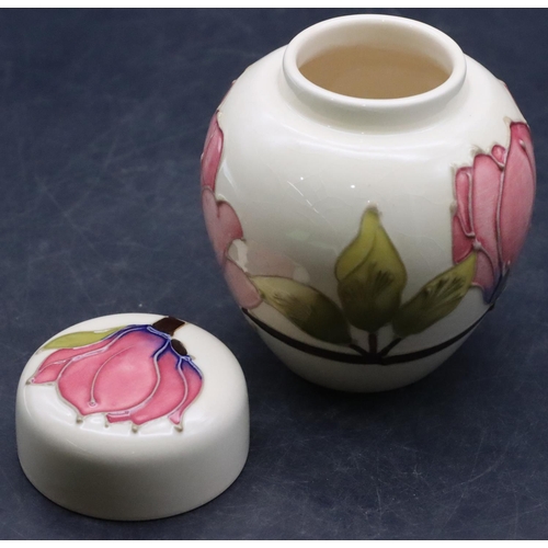 157 - A modern Moorcroft round bulbous lidded ginger jar on cream ground with multi-coloured floral and le... 