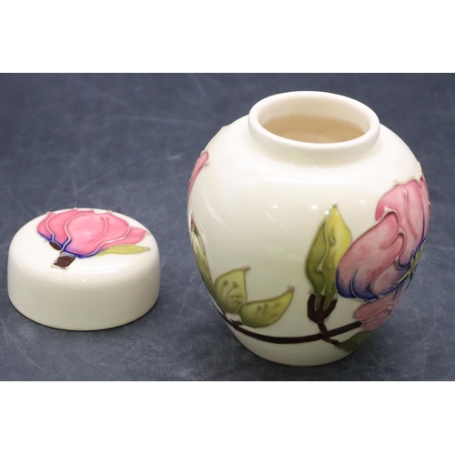 157 - A modern Moorcroft round bulbous lidded ginger jar on cream ground with multi-coloured floral and le... 