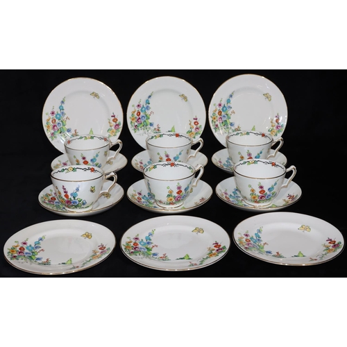 16 - A Crown Staffordshire tea service on white ground with multi-coloured butterfly, floral and garden d... 