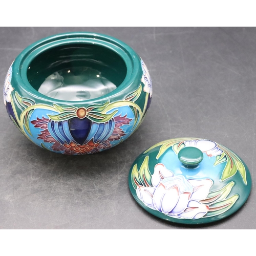 160 - A modern Moorcroft round bulbous lidded pot on turquoise and green ground with multi-coloured floral... 