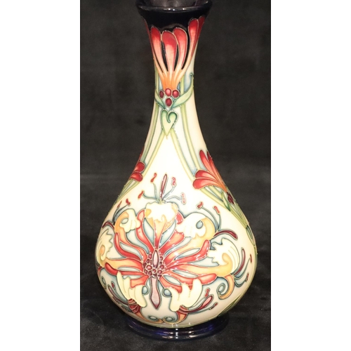 162 - A modern Moorcroft round bulbous thin necked trumpet shaped vase on cream and blue ground with multi... 