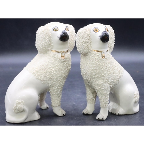 168 - A pair of 19th Century Staffordshire figures of seated spaniels on white ground with encrusted decor... 