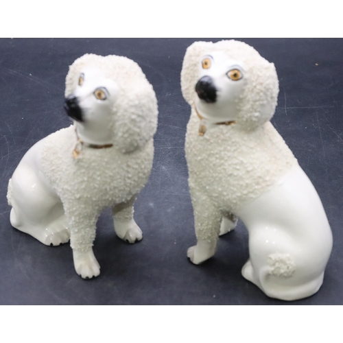 168 - A pair of 19th Century Staffordshire figures of seated spaniels on white ground with encrusted decor... 