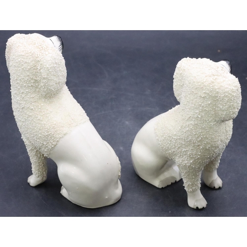 168 - A pair of 19th Century Staffordshire figures of seated spaniels on white ground with encrusted decor... 