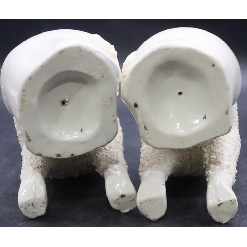 168 - A pair of 19th Century Staffordshire figures of seated spaniels on white ground with encrusted decor... 