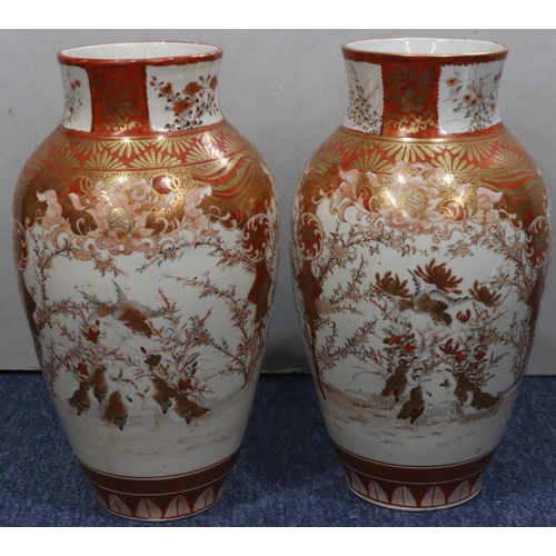 180 - A pair of Oriental round bulbous thin necked vases on white and red ground with coloured bird, lands... 