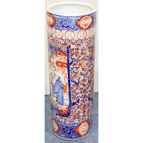 185 - An Imari cylindrical umbrella stand with pierced rim on white, red and blue ground and allover figur... 