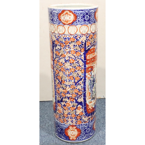 185 - An Imari cylindrical umbrella stand with pierced rim on white, red and blue ground and allover figur... 