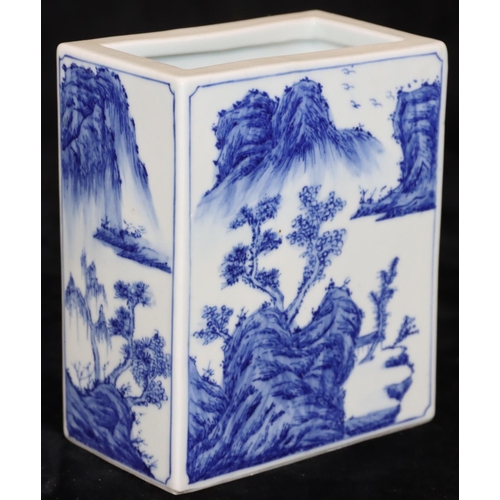 21 - An Oriental rectangular brick shaped brush pot on blue and white ground with river landscape, buildi... 