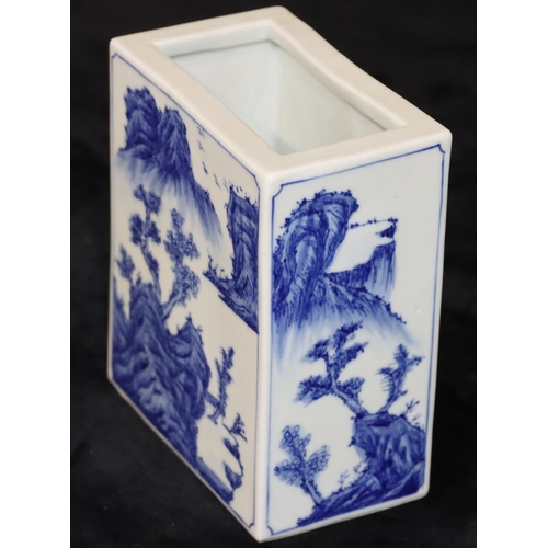 21 - An Oriental rectangular brick shaped brush pot on blue and white ground with river landscape, buildi... 