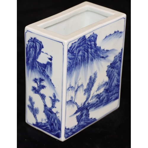 21 - An Oriental rectangular brick shaped brush pot on blue and white ground with river landscape, buildi... 