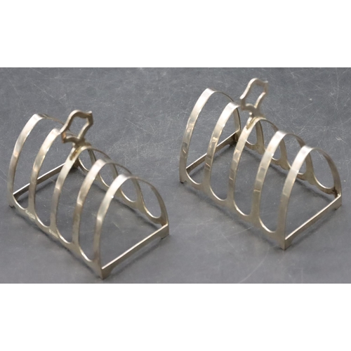 243 - A pair of Birmingham silver 5-bar toast racks with centre carrying handles, maker's mark Cairncross,... 