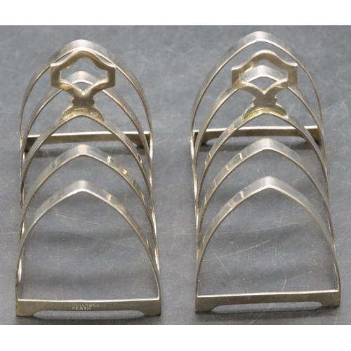 243 - A pair of Birmingham silver 5-bar toast racks with centre carrying handles, maker's mark Cairncross,... 