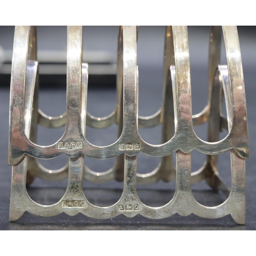 243 - A pair of Birmingham silver 5-bar toast racks with centre carrying handles, maker's mark Cairncross,... 