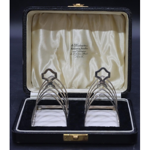 243 - A pair of Birmingham silver 5-bar toast racks with centre carrying handles, maker's mark Cairncross,... 