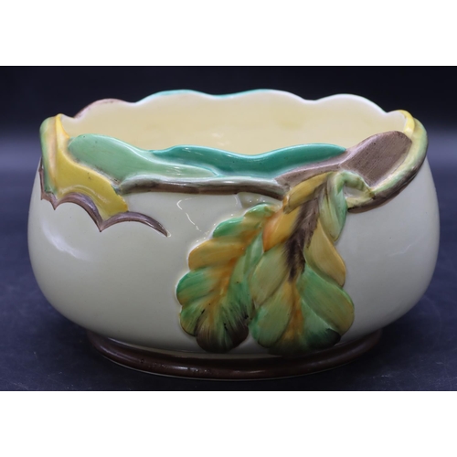 39 - A Clarice Cliff round bulbous fruit bowl on cream ground with raised coloured leaf and scroll decora... 