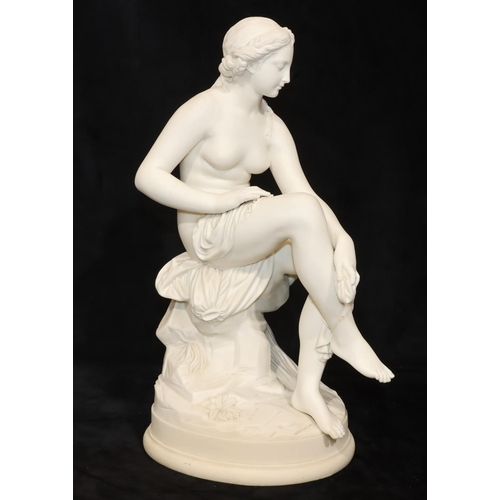 47 - A Parian figure of a female seated nude, on round base, 43cm high (Right leg restored just above ank... 