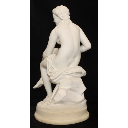 47 - A Parian figure of a female seated nude, on round base, 43cm high (Right leg restored just above ank... 