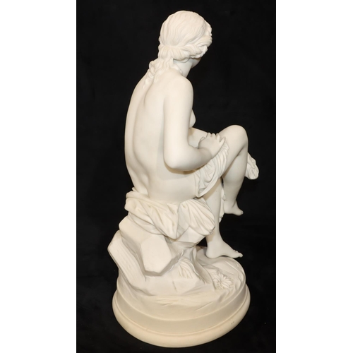 47 - A Parian figure of a female seated nude, on round base, 43cm high (Right leg restored just above ank... 