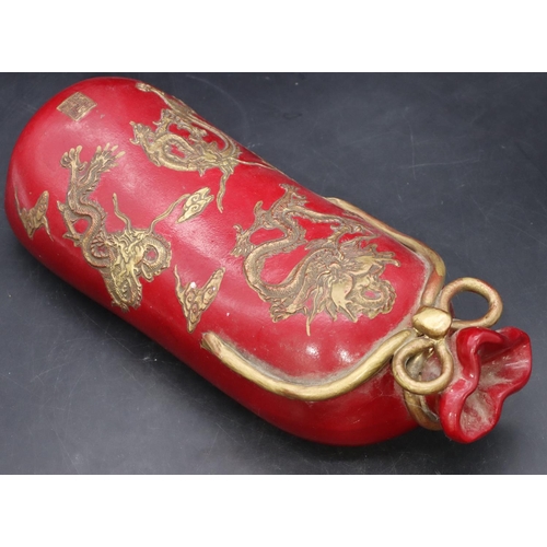 50 - An Oriental earthenware pillow in the form of a bag on red ground with gilt dragon decoration, 33cm ... 